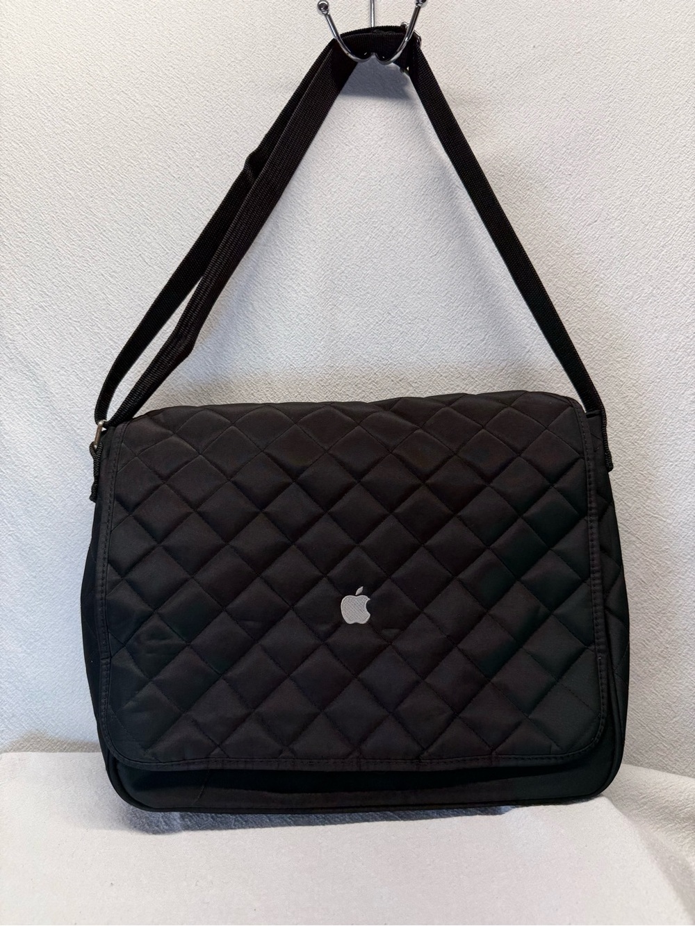 Easy travel Apple quilted messenger-style shoulder bag featuring an Apple Logo